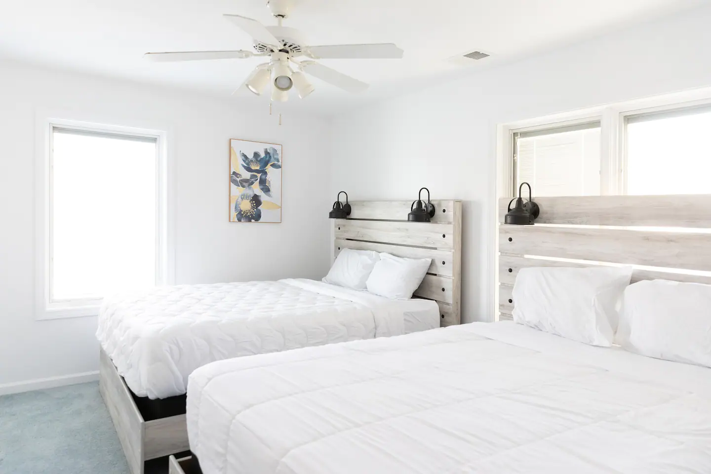 Bedroom 3 on the second level has two queen beds, a walk-in closet, and a 70-inch HDTV.