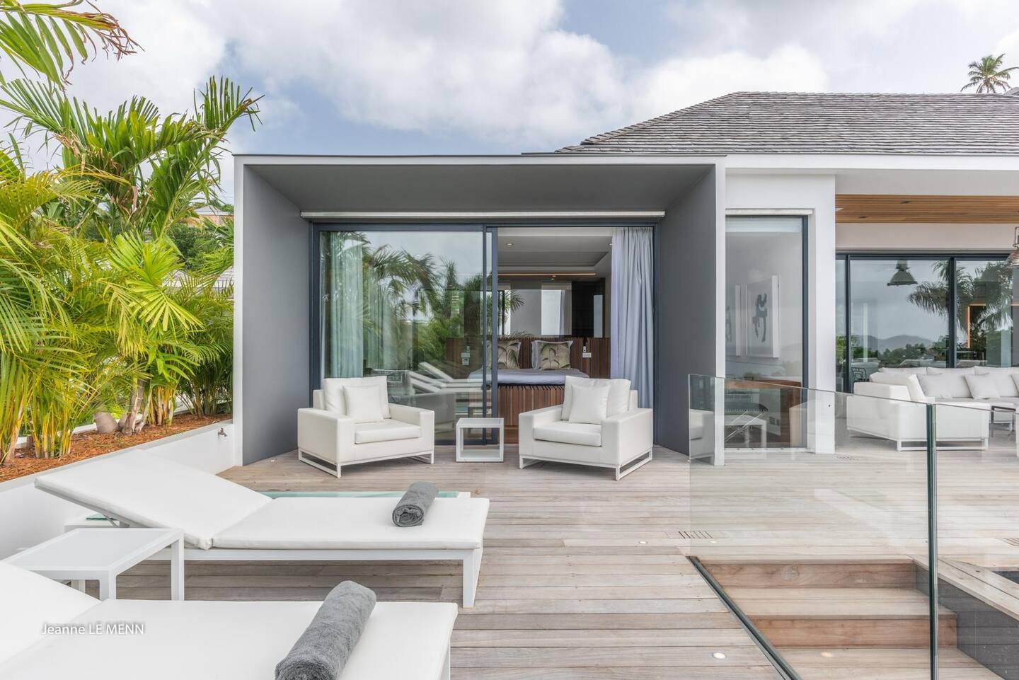 The patio has a heated infinity pool, a Jacuzzi, and plenty of lounge seats.