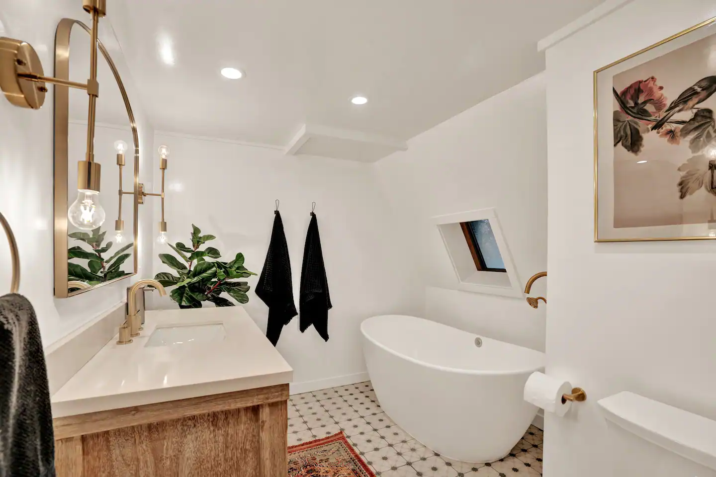 Easy access to the bathroom furnished with a bath tub.