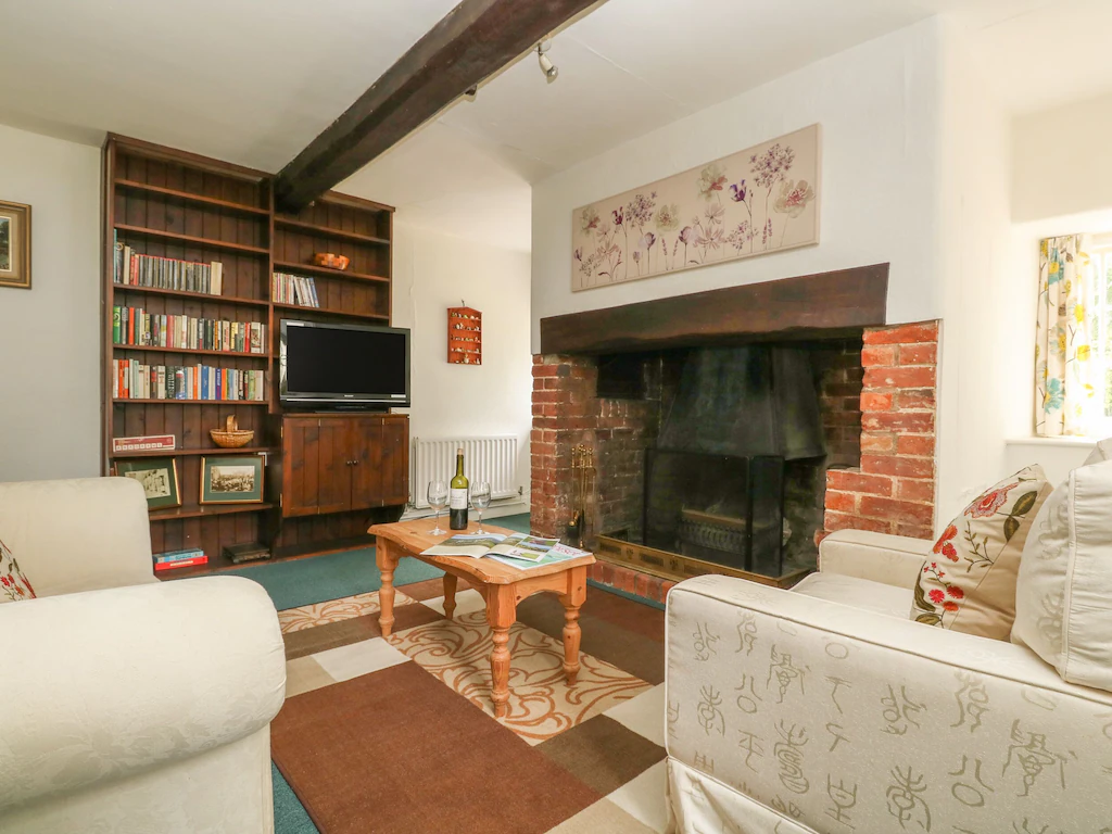 A conservatory and a living area with an open fire