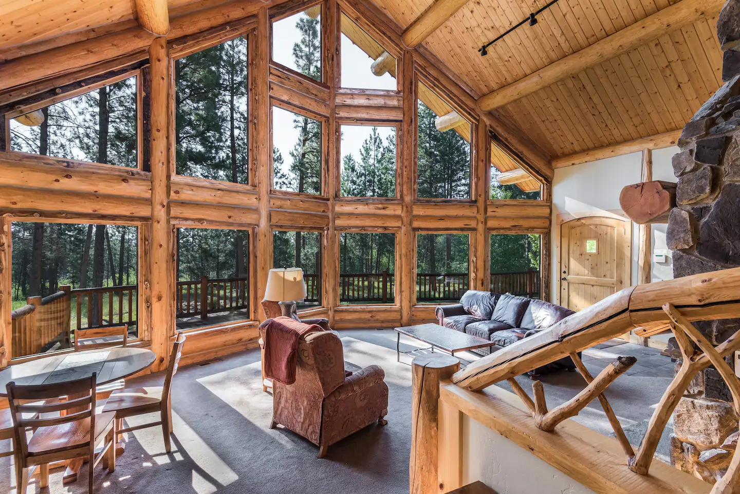 Large family area with high ceilings and expansive windows.