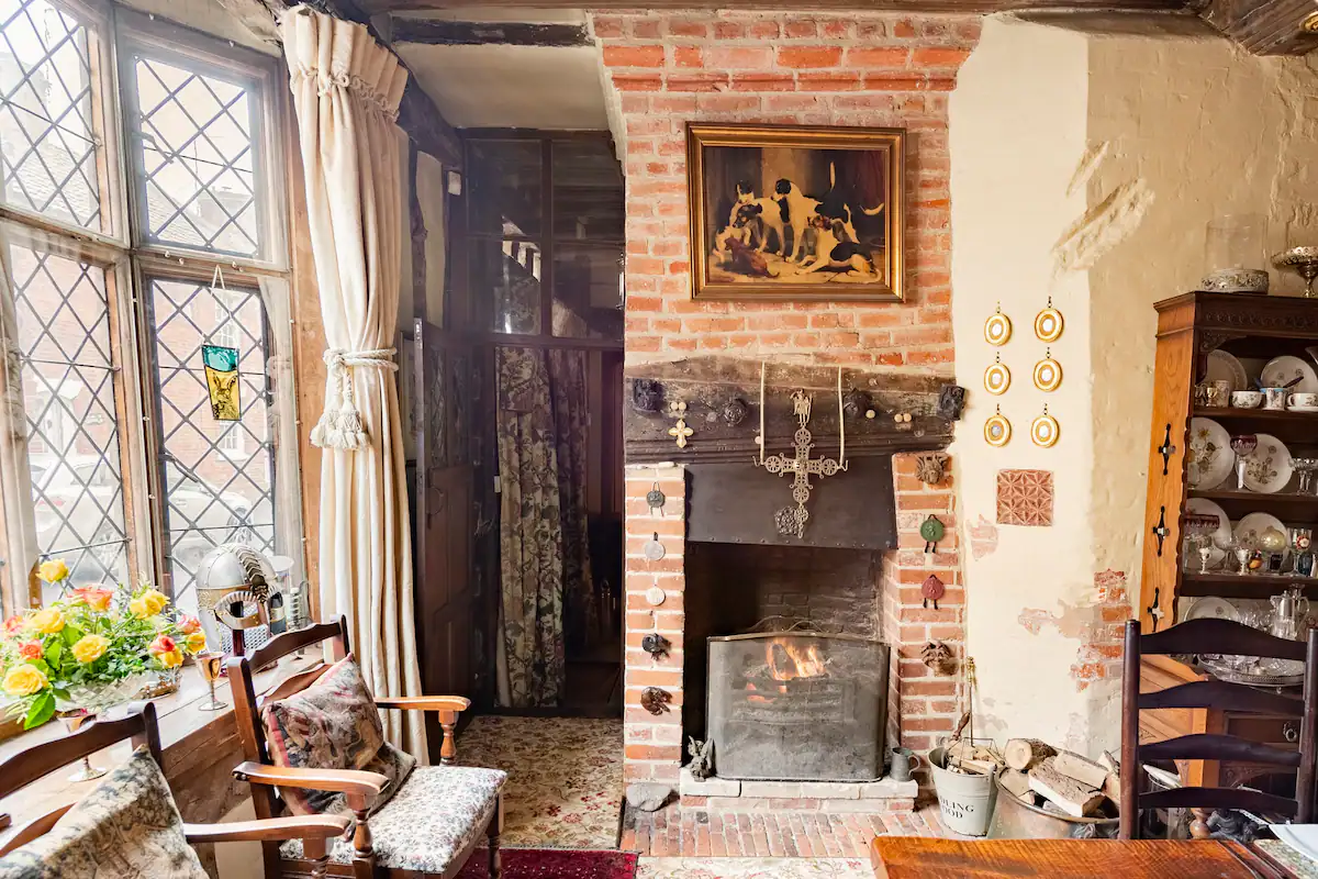 The dining room with original leaded light windows and original fireplace.