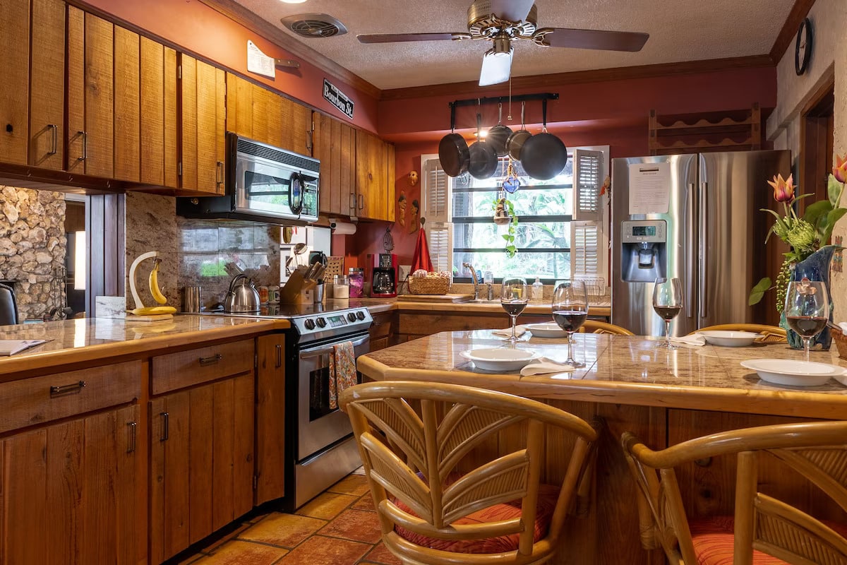 Fully stocked kitchen, including cooking spices and coffee supplies, with peninsula and comfortable seating for 4.