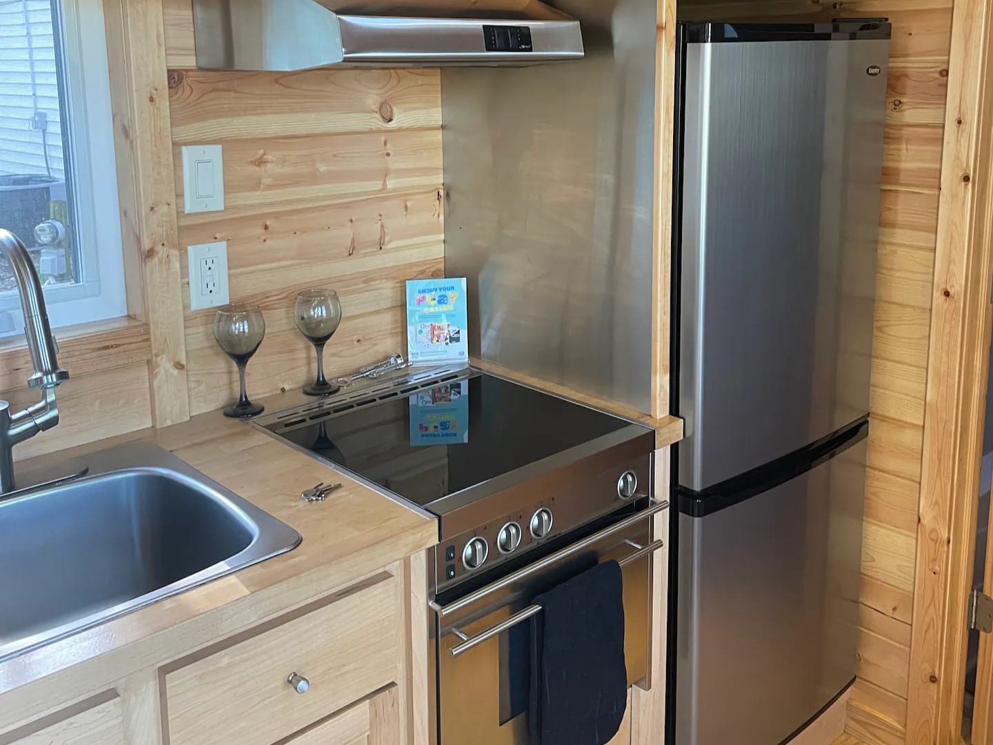 Inside there's apartment size refrigerator, a propane cooktop with four burners, microwave and all utensils and cooking supplies.