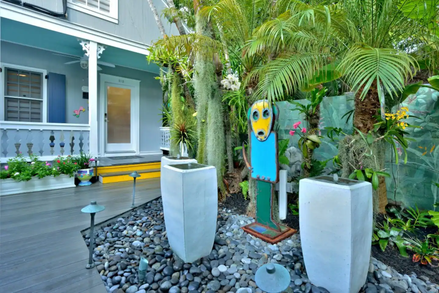 John Martini sculpture, 3 white fountains and orchids in the garden setting.